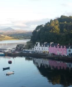 A line of brightly painted houses of different colours, along the harbour side in Portree on our Isle of Skye and Dunvegan Castle Tour