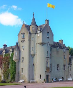 Ballindalloch Castle on the Ballindalloch Castle and Speyside Tour Ballindalloch Castle on the North East 250 Tour fills this picture from side to side. It is a lived-in castle from 1500's, finished in a delicate pink harling. It's yellow flag flies from the top of the five-storey tower.