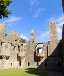 Photograph of the Earls Palace in Kirkwall. This is a ruin dating from the 1600's, photographed in bright sunshine with blue sky above.